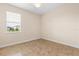 Neutral bedroom features a ceiling fan, tiled floors, and a single window with blinds at 3578 Cortland Dr, Davenport, FL 33837