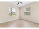 Neutral-toned bedroom features tiled floors, two windows with blinds, and a ceiling fan at 3578 Cortland Dr, Davenport, FL 33837