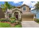Charming two-story home with a well-manicured lawn and a two-car garage. Landscaping adds to the curb appeal at 3578 Cortland Dr, Davenport, FL 33837