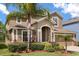Charming two-story home with a well-manicured lawn and mature palm trees at 3578 Cortland Dr, Davenport, FL 33837