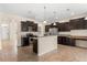 Spacious kitchen with modern appliances, dark wood cabinets, and granite countertops at 3578 Cortland Dr, Davenport, FL 33837