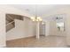 Spacious living room featuring tile floors, neutral walls, staircase, and elegant archways at 3578 Cortland Dr, Davenport, FL 33837