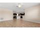 Open-concept living room with neutral paint, tile floors, and views of the adjacent kitchen at 3578 Cortland Dr, Davenport, FL 33837