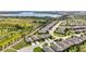 Aerial view of new community with streetscapes, lake views, and modern home designs at 3744 Quaint Ln, Clermont, FL 34711