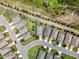 An aerial view of a residential neighborhood showing home placement and beautiful surroundings at 3744 Quaint Ln, Clermont, FL 34711