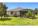 Charming home with a spacious backyard featuring a screened lanai and well-maintained lawn at 3744 Quaint Ln, Clermont, FL 34711