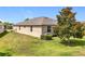 Backyard view of the property showcasing its well-maintained landscaping and privacy at 3744 Quaint Ln, Clermont, FL 34711