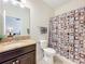 Bathroom with a granite vanity and a shower-tub combination with a patterned curtain at 3744 Quaint Ln, Clermont, FL 34711
