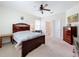 Bedroom featuring a floral bedspread, natural light, and ceiling fan at 3744 Quaint Ln, Clermont, FL 34711