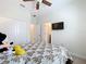 Bedroom with double closet doors and a wall-mounted television at 3744 Quaint Ln, Clermont, FL 34711