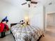 Bedroom with a ceiling fan, carpeted floor, and double closet doors at 3744 Quaint Ln, Clermont, FL 34711