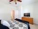 Bright bedroom with ceiling fan, neutral walls, and black and white patterned bedding at 3744 Quaint Ln, Clermont, FL 34711