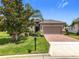 Charming home with well-maintained lawn, mature tree and brick-paved driveway at 3744 Quaint Ln, Clermont, FL 34711