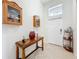 Inviting foyer with tiled floor, decorative table and display cabinets at 3744 Quaint Ln, Clermont, FL 34711