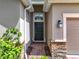Welcoming entryway with decorative brick accents and tasteful landscaping at 3744 Quaint Ln, Clermont, FL 34711