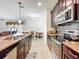 Open concept kitchen with granite counters, tile backsplash, and eat-in dining area at 3744 Quaint Ln, Clermont, FL 34711