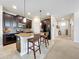 Open-concept kitchen featuring a center island, barstool seating, and views into the entryway at 3744 Quaint Ln, Clermont, FL 34711