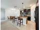 Stylish kitchen with dark wood cabinets, granite countertops, and modern appliances at 3744 Quaint Ln, Clermont, FL 34711