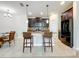 Well-lit kitchen with stainless steel appliances, tile backsplash and breakfast bar at 3744 Quaint Ln, Clermont, FL 34711