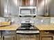 Close-up of kitchen with stainless steel appliances and granite countertops at 3744 Quaint Ln, Clermont, FL 34711