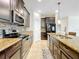 Well-equipped kitchen with granite countertops, stainless steel appliances, and decorative tile backsplash at 3744 Quaint Ln, Clermont, FL 34711