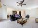 Bright living room showcases an open floor plan with views of the kitchen and dining area at 3744 Quaint Ln, Clermont, FL 34711