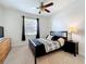 Inviting main bedroom with a ceiling fan, natural light, and a dresser for storage at 3744 Quaint Ln, Clermont, FL 34711