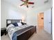 Serene main bedroom features a ceiling fan, side table and easy access to the bathroom at 3744 Quaint Ln, Clermont, FL 34711