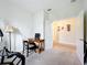 Bright office featuring a desk, chair, and view into adjacent rooms at 3744 Quaint Ln, Clermont, FL 34711
