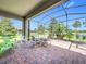 Screened patio with brick pavers, surrounded by lush landscaping, perfect for outdoor relaxation and entertainment at 3744 Quaint Ln, Clermont, FL 34711