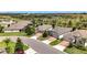 Picturesque neighborhood street featuring well-kept homes with brick driveways and lush greenery at 3744 Quaint Ln, Clermont, FL 34711