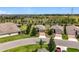 Beautiful street view of suburban homes with manicured lawns, brick driveways, and mature landscaping at 3744 Quaint Ln, Clermont, FL 34711