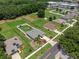 Aerial view of home in Umatilla with lawn, privacy fence, and surrounding greenery at 382 Lake St, Umatilla, FL 32784