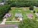 Aerial view of house on a large lot with a privacy fence, and a two-car garage at 382 Lake St, Umatilla, FL 32784