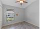 This bedroom features a large window allowing for natural light and a closet for storage at 382 Lake St, Umatilla, FL 32784