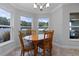 Charming breakfast nook with a wooden table, comfortable seating, and views of the backyard at 382 Lake St, Umatilla, FL 32784