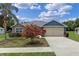 Charming single-story home with stone accents, a two-car garage and flowering bushes at 382 Lake St, Umatilla, FL 32784