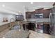 Modern kitchen with granite countertops, stainless steel appliances, and dark wood cabinets at 382 Lake St, Umatilla, FL 32784
