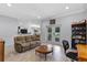 Spacious living room with a comfy couch, coffee table, and double doors leading to a fenced-in backyard at 382 Lake St, Umatilla, FL 32784