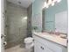 Modern bathroom featuring a walk-in shower with tile surround, and a vanity with a light-colored countertop at 4413 Lions Gate Ave, Clermont, FL 34711