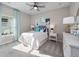 Bright bedroom featuring a ceiling fan, a queen-sized bed, and stylish decor with natural light at 4413 Lions Gate Ave, Clermont, FL 34711