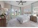Spacious bedroom featuring large windows, a ceiling fan, and neutral tones at 4413 Lions Gate Ave, Clermont, FL 34711