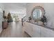 Bright entryway with elegant console table, decorative mirror, and views into a cozy living area at 4413 Lions Gate Ave, Clermont, FL 34711