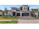 Beautiful two-story home with stone accents, manicured lawn, and a three-car garage at 4413 Lions Gate Ave, Clermont, FL 34711