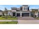 Stunning two-story home featuring a stone facade, manicured lawn, and a two-car garage at 4413 Lions Gate Ave, Clermont, FL 34711