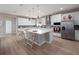 Bright kitchen featuring white cabinetry, stainless steel appliances, and a center island at 4413 Lions Gate Ave, Clermont, FL 34711