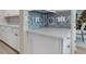 Close-up of modern kitchen island featuring white counter top and shaker style cabinets at 4413 Lions Gate Ave, Clermont, FL 34711