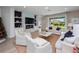 Comfortable living room with fireplace, built-in shelves, and sliding glass doors to the outdoor patio at 4413 Lions Gate Ave, Clermont, FL 34711