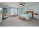 Spacious main bedroom with windows and carpet floors. Features natural textures and light colors at 4413 Lions Gate Ave, Clermont, FL 34711