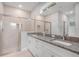 Bright bathroom with granite countertops, double sinks, and glass enclosed shower at 4780 Sw 129Th Pl, Ocala, FL 34473